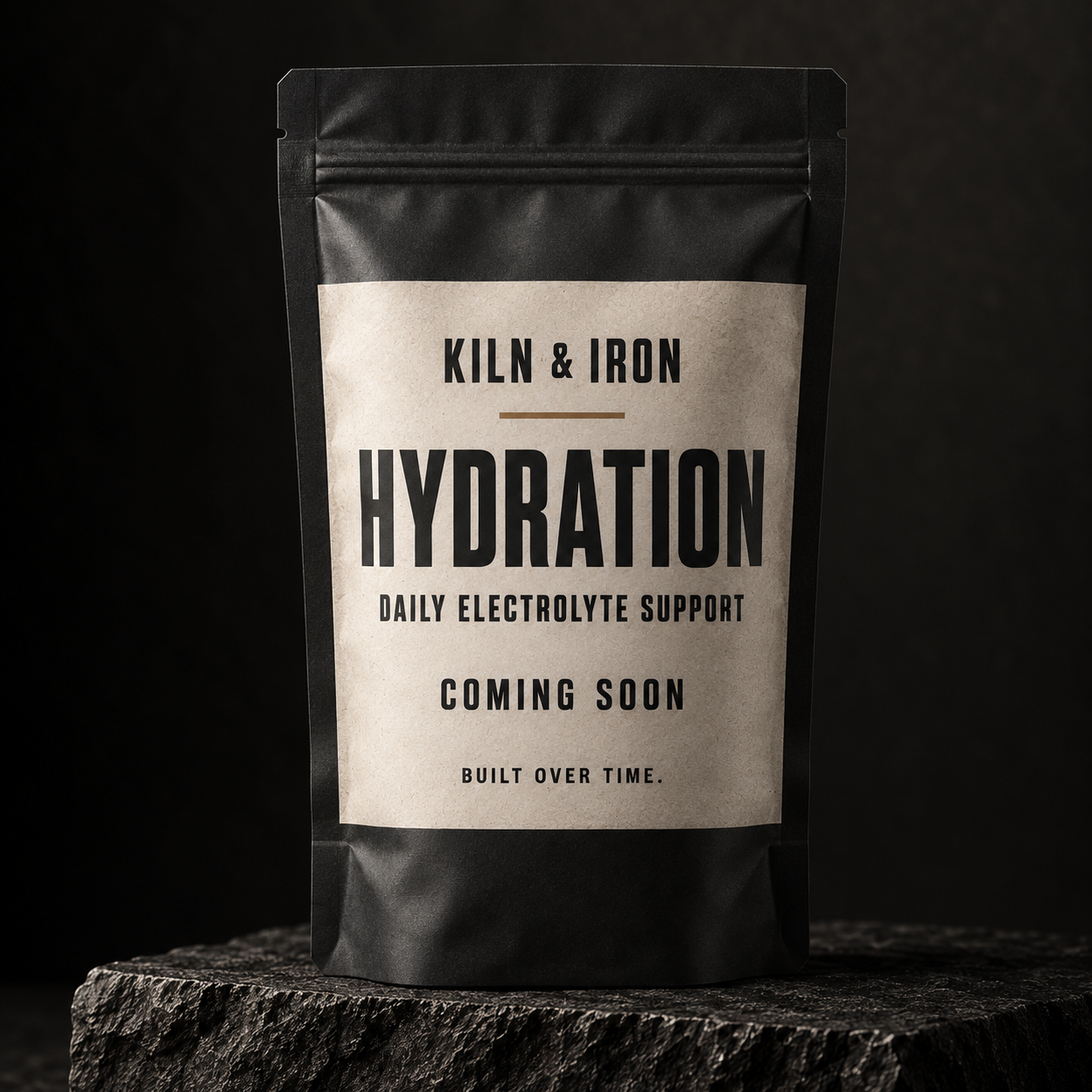 Concept rendering of a slim matte KILN & IRON Hydration pouch labeled Daily Electrolyte Support, Coming Soon, and Built Over Time